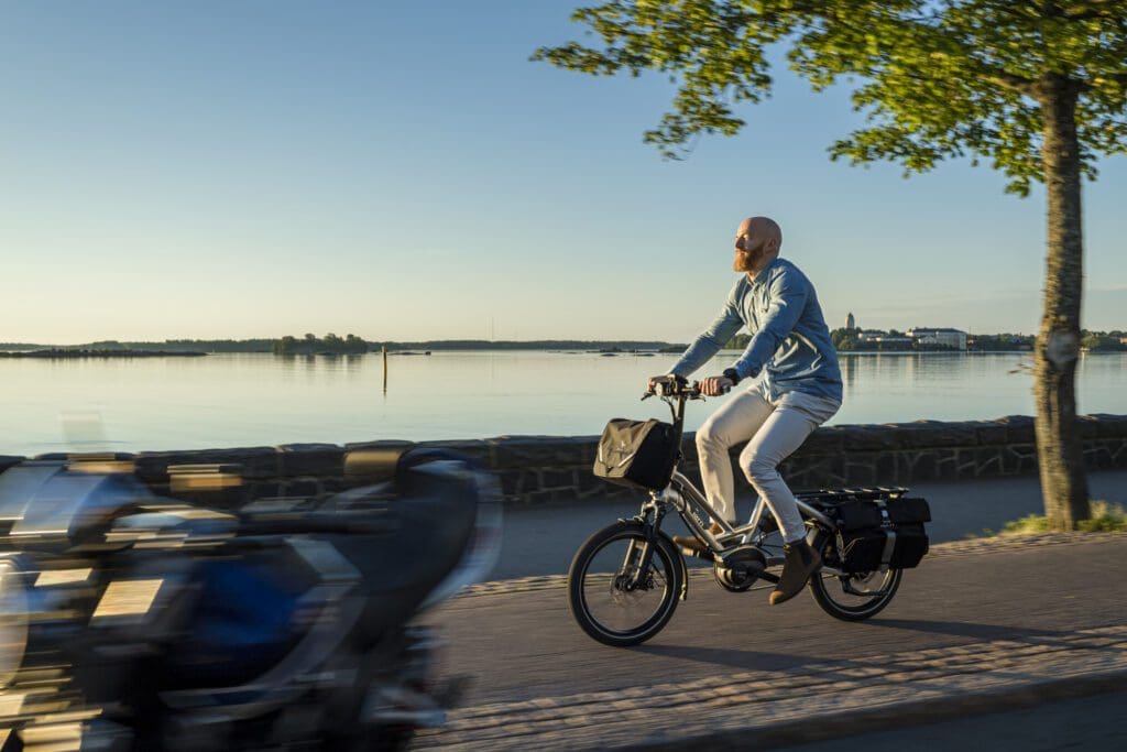 Man cycling by the sea in Kaivopuisto, Helsinki.